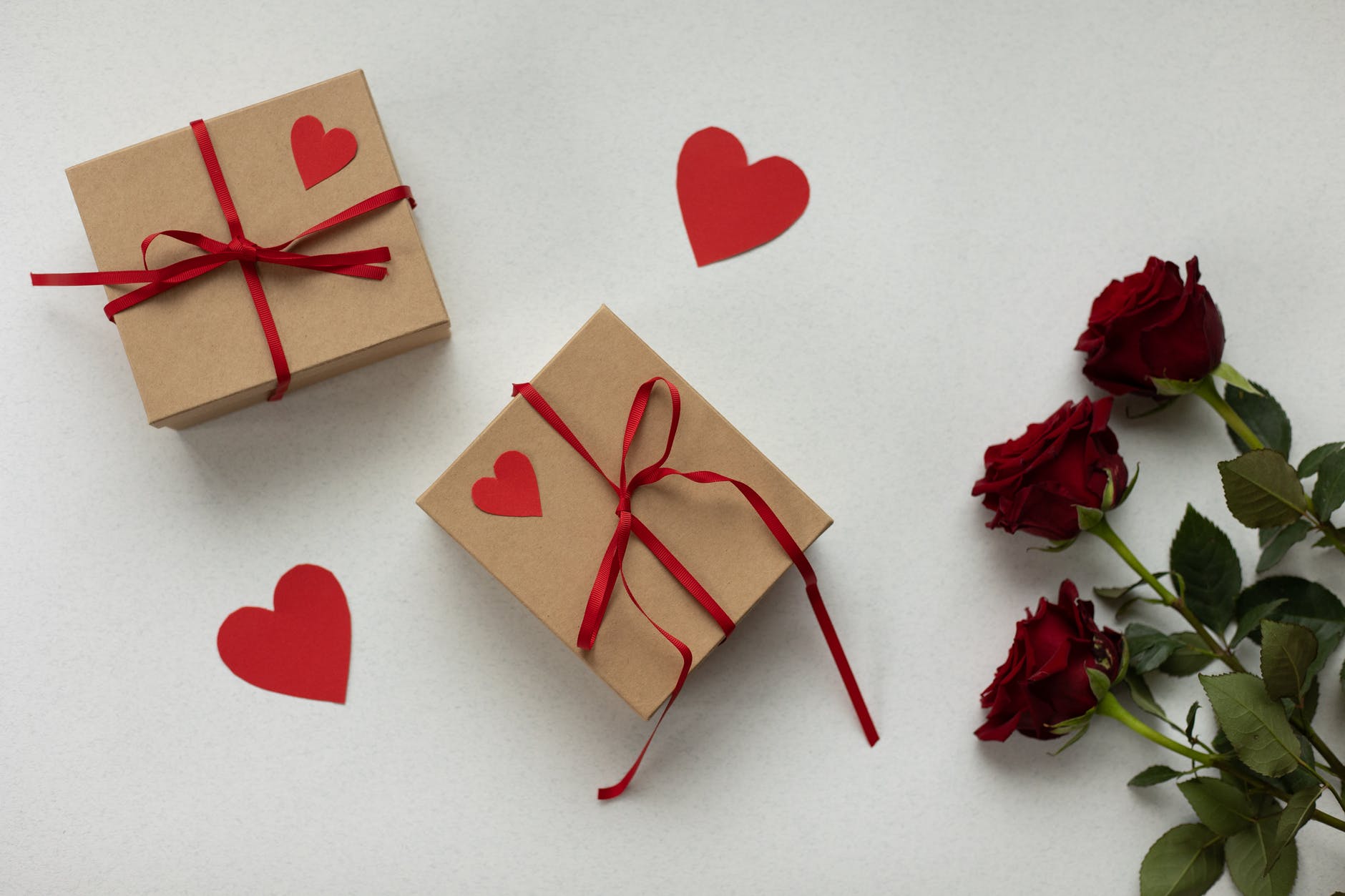 gift boxes on table with roses