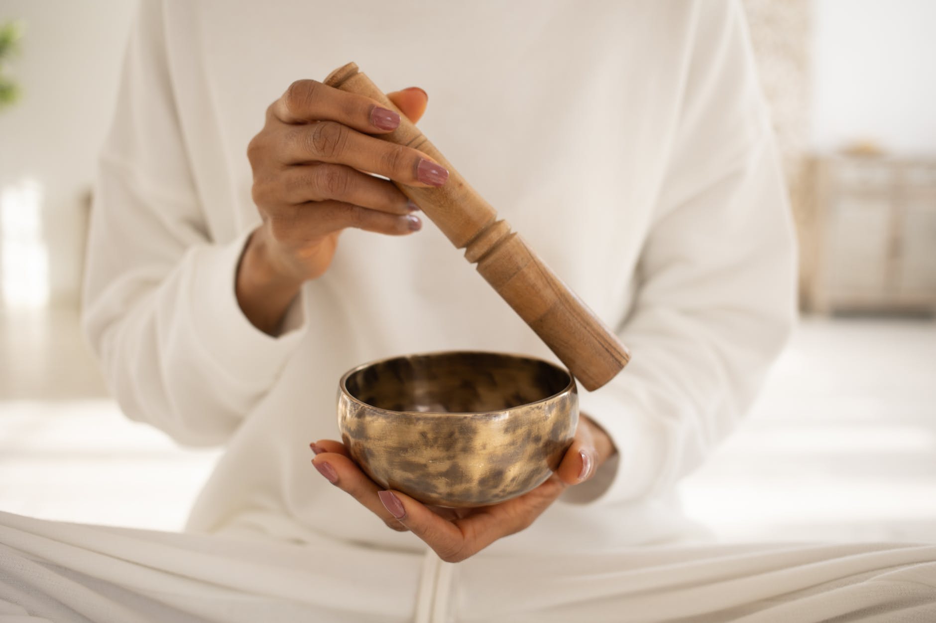 close up shot of a person using a singing bowl